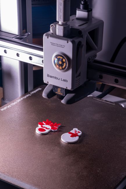 Compact Bambu Lab A1 Mini 3D printer printing a multicolor model.