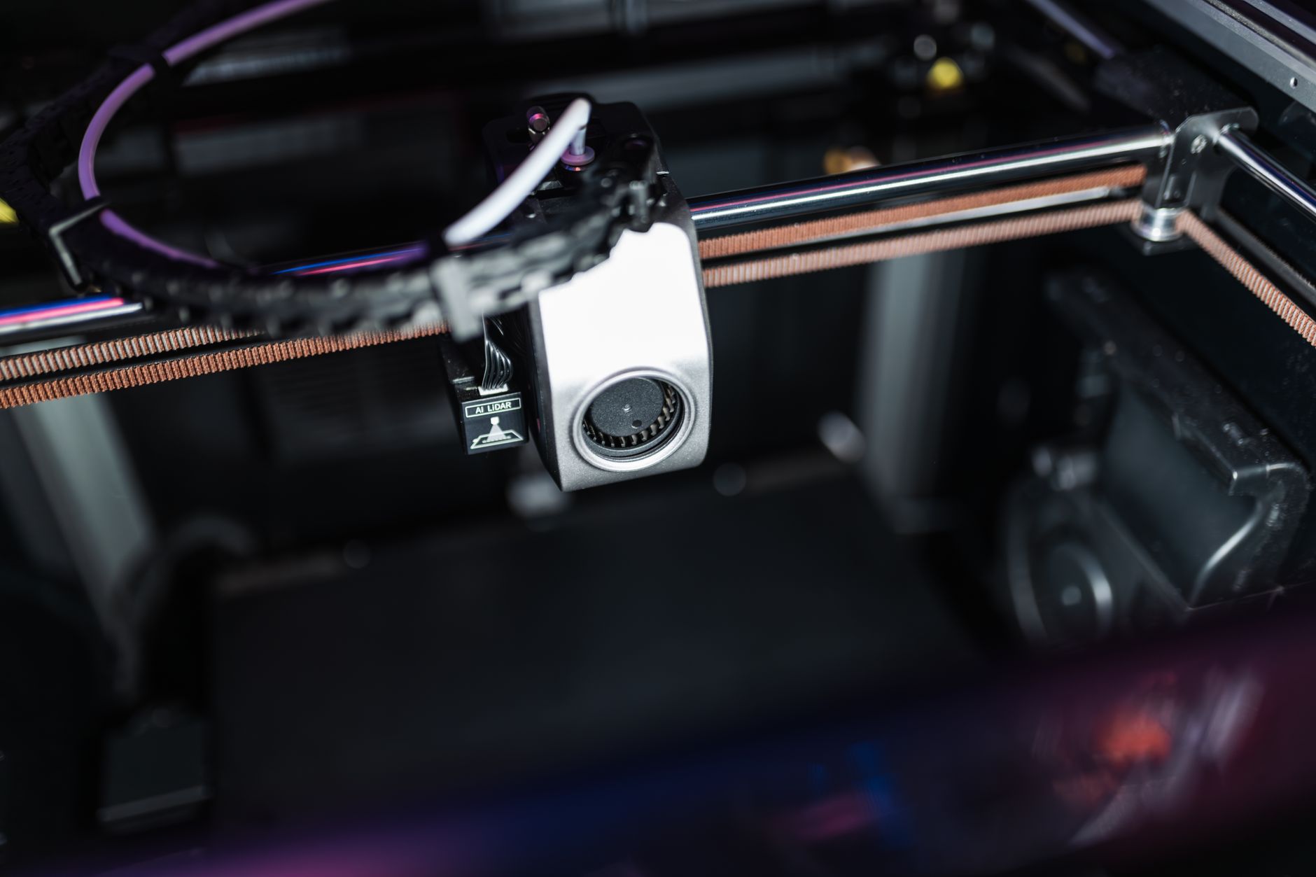 Bambu Lab P1S enclosed 3D printer printing an orange object